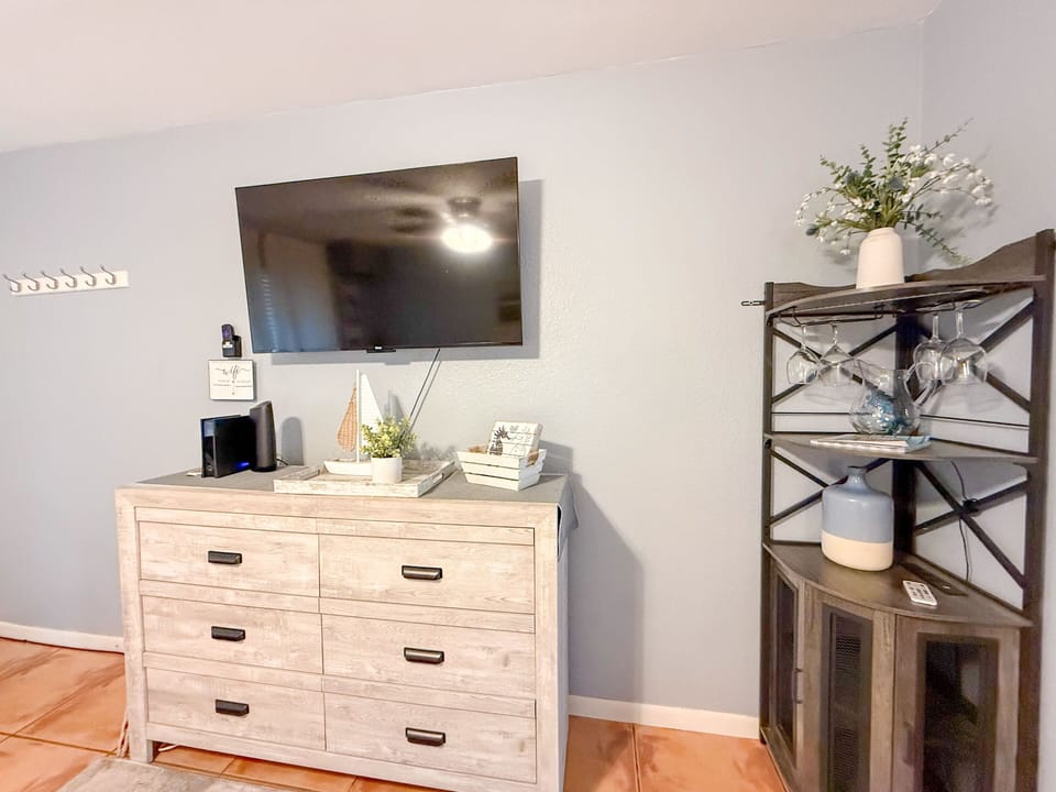 Discover the perfect blend of style and functionality with this elegant white dresser. Complete with a charming lamp, it provides ample storage while enhancing your room's decor. Experience comfort and beauty during your stay! 