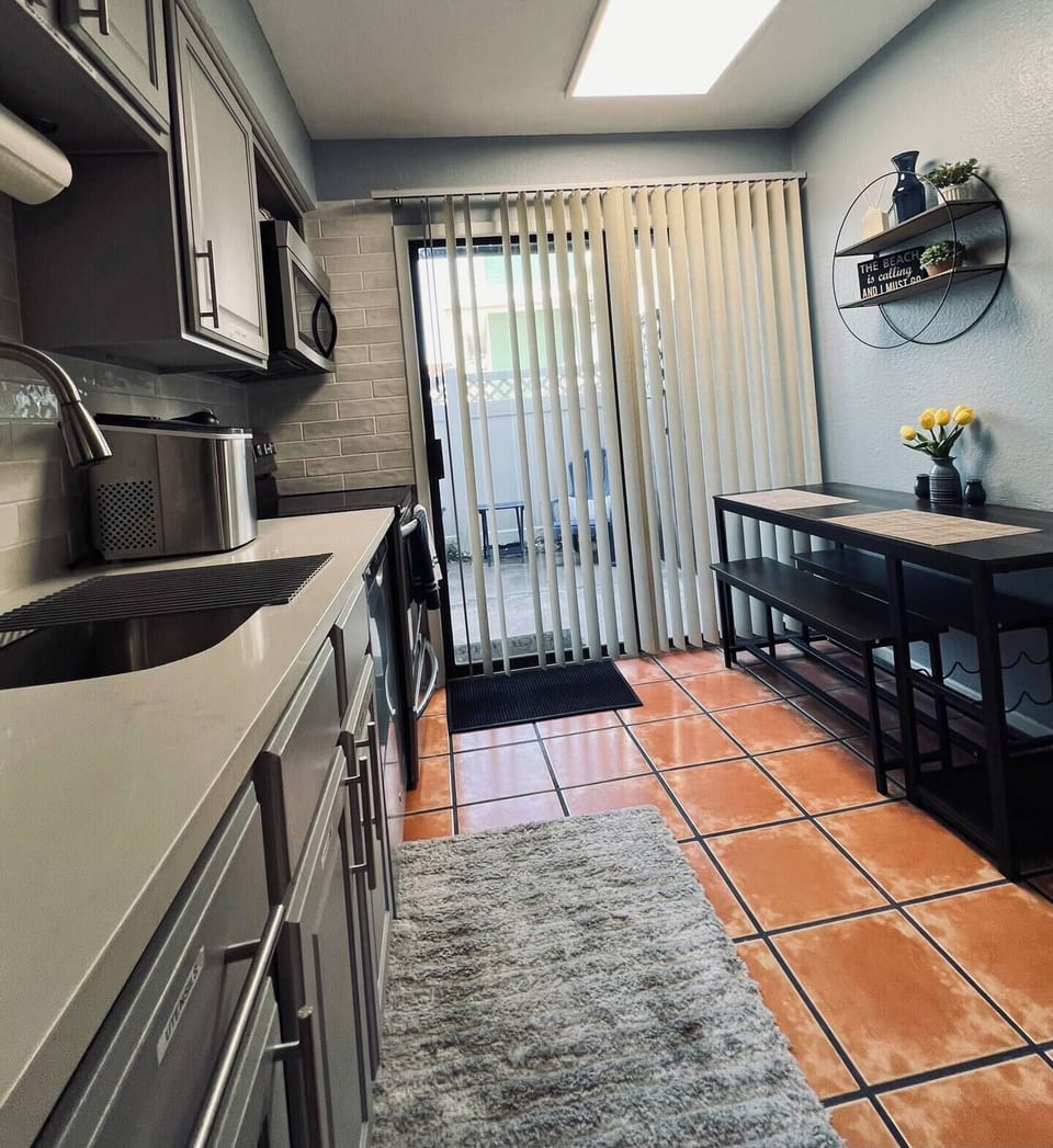 Discover the charm of our spacious kitchen, featuring elegant tile flooring that combines style and functionality. Equipped with modern appliances and ample cabinetry, it’s the perfect space for culinary adventures or enjoying a cozy meal at home.