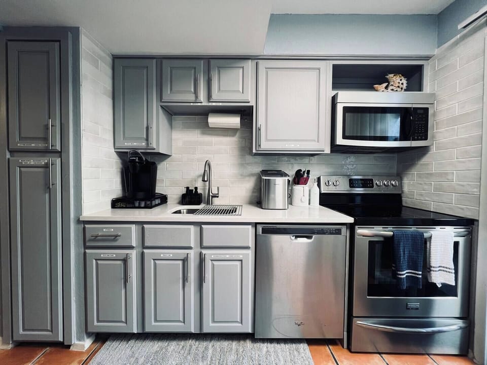 Step into this bright, modern kitchen where style meets function. Enjoy ample storage and sleek countertops—perfect for crafting delicious meals. Your ideal getaway begins here!