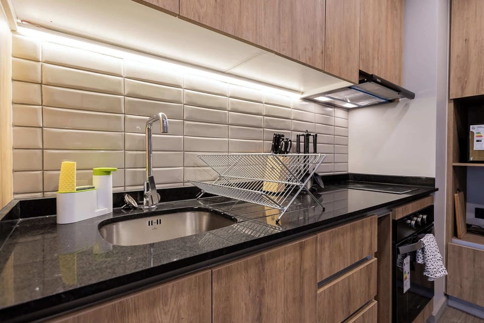 Sleek and modern kitchen with stylish wooden cabinets and granite countertops, perfect for culinary adventures.