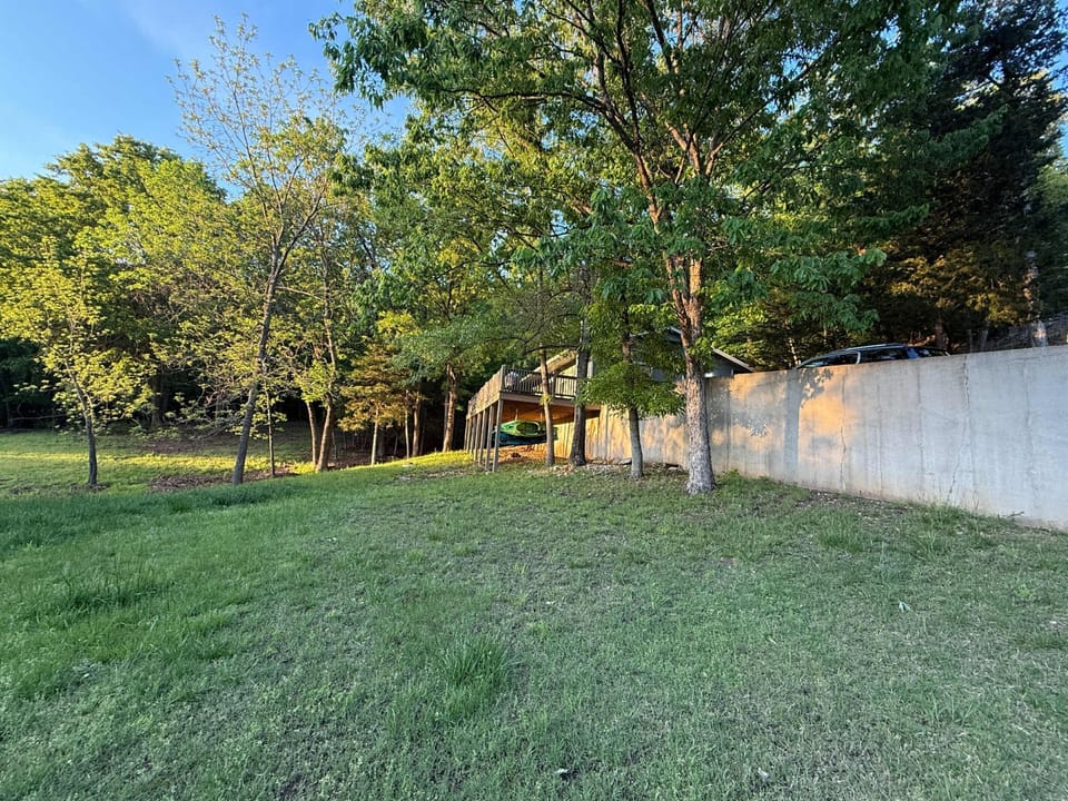 Spacious front yard surrounded by woods, peace, and nature.