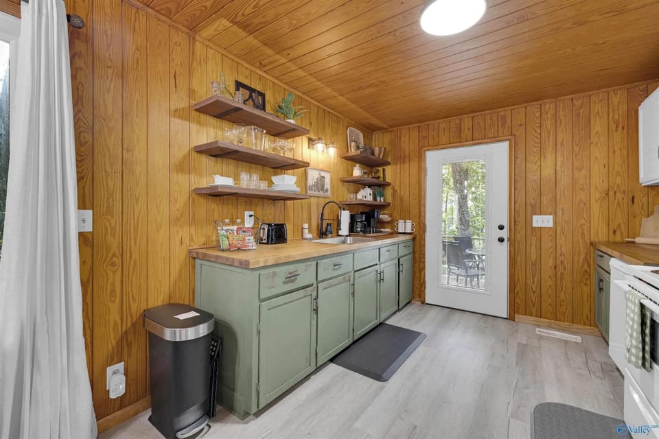 Full kitchen includes refrigerator, oven microwave toaster, and blender dishes