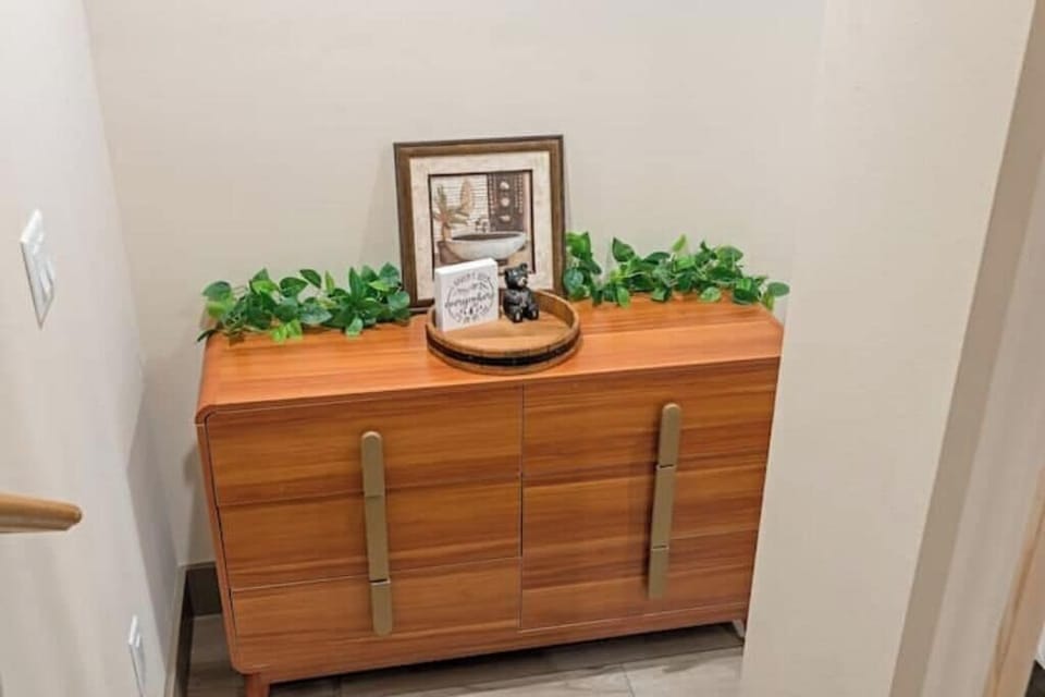 Mid-century dresser with greenery, framed art & a welcome sign for style!