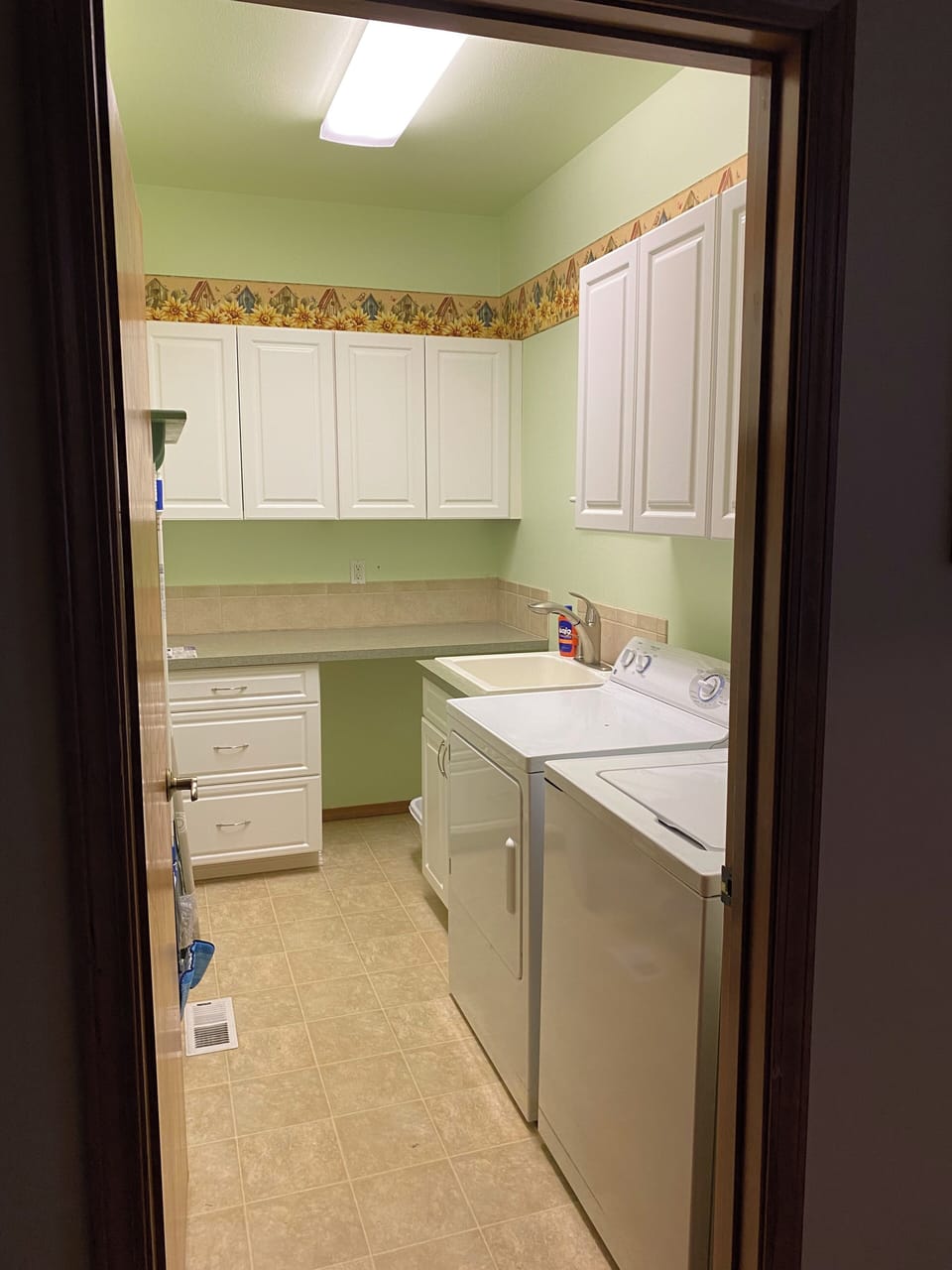 Laundry room with iron and ironing board
