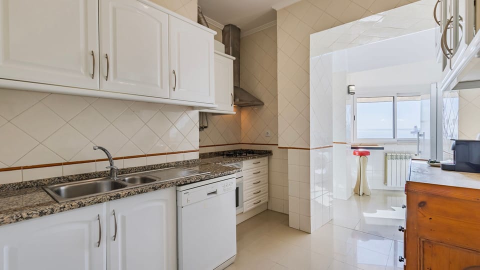 A well-equipped kitchen with natural light and views to inspire your cooking. #KitchenGoals #CozyLiving #Portugal #PT #Lisbon