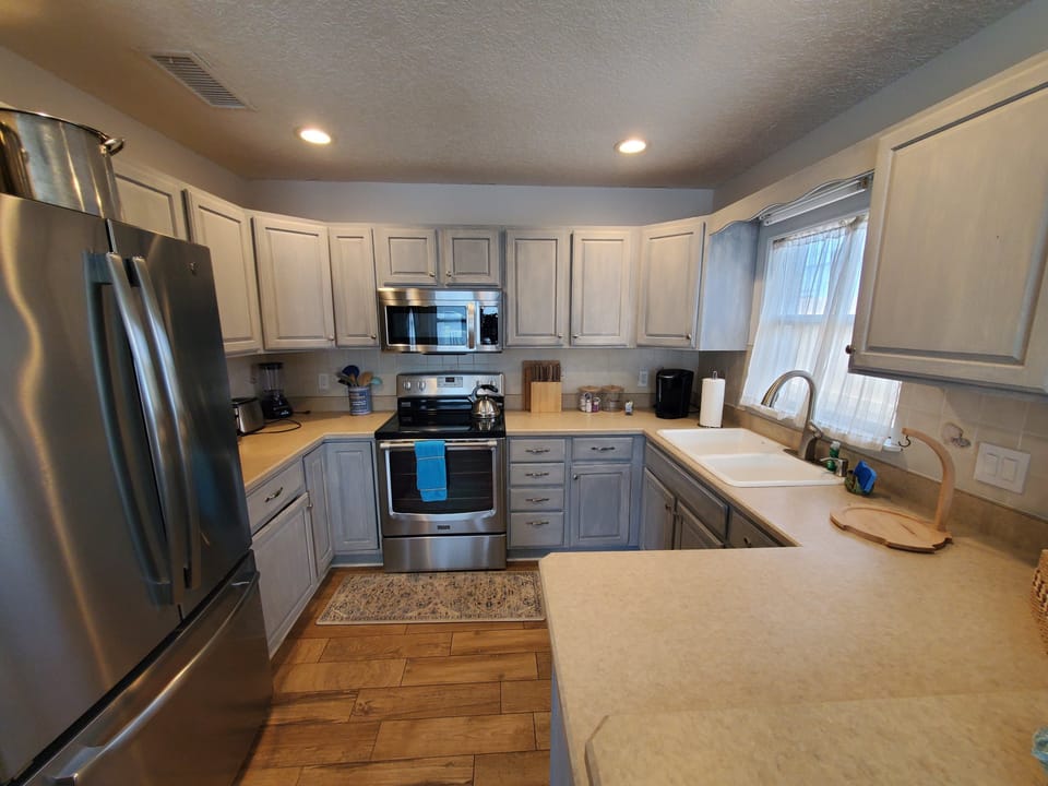 Fully-equipped modern kitchen with stainless steel appliances.