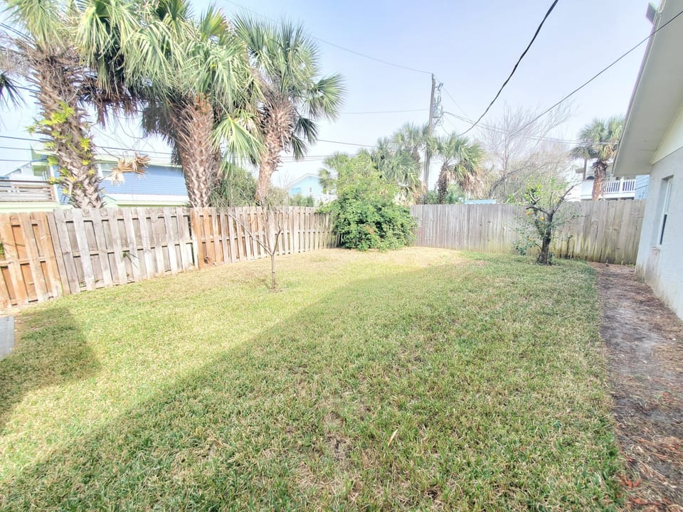 Spacious private backyard with lush grass, ideal for outdoor fun.