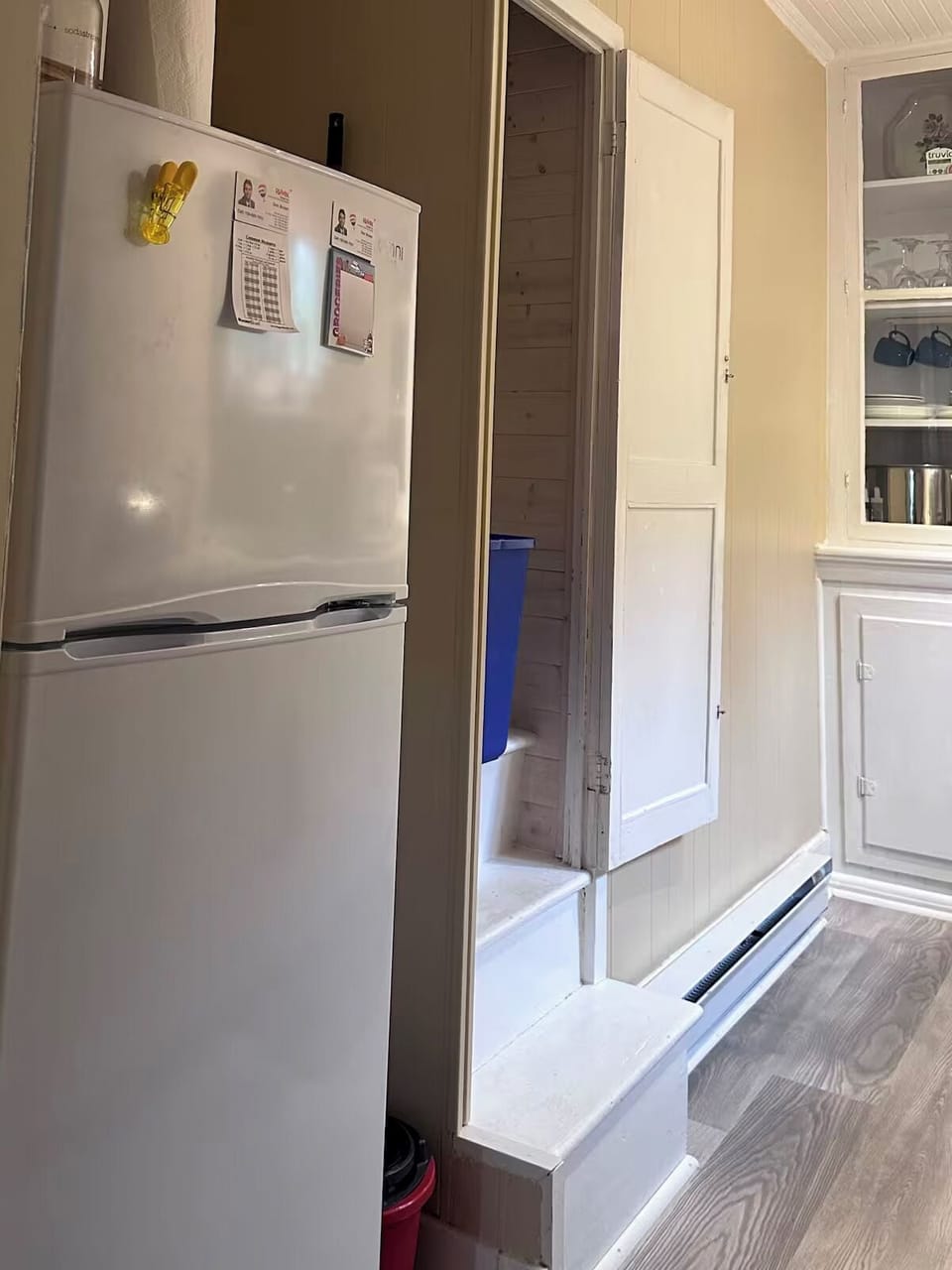 Full-size refrigerator, and the doorway & stairs to the attic bedroom.