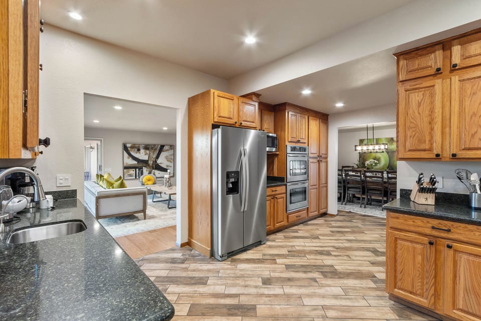 Fully stocked kitchen, wine fridge, double oven and stainless steel. Access to dining room.