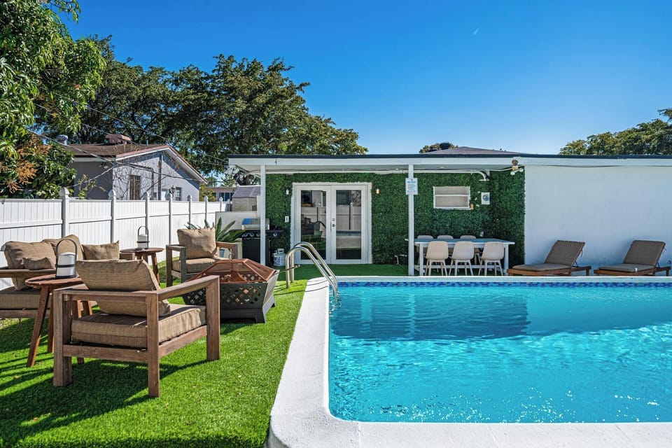  Cozy backyard with a pool and lounge area.