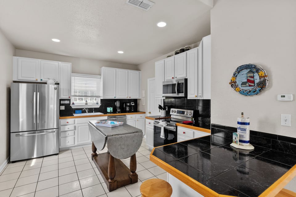 Fully equipped kitchen with modern appliances and plenty of prep space.
