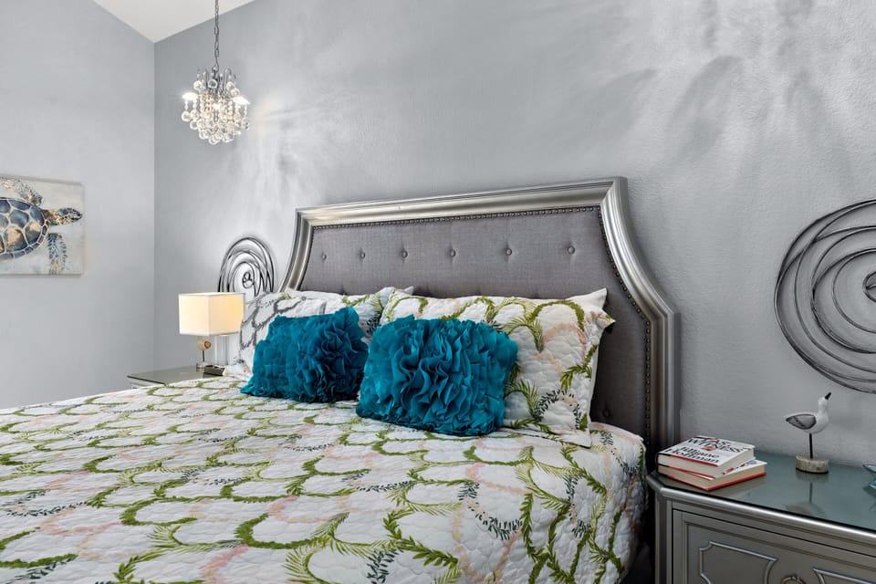 Chic master retreat with plush bedding and relaxing seaside hues