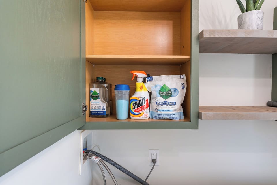 Laundry room stocked with 7th generation detergent, soaps, and stainremover