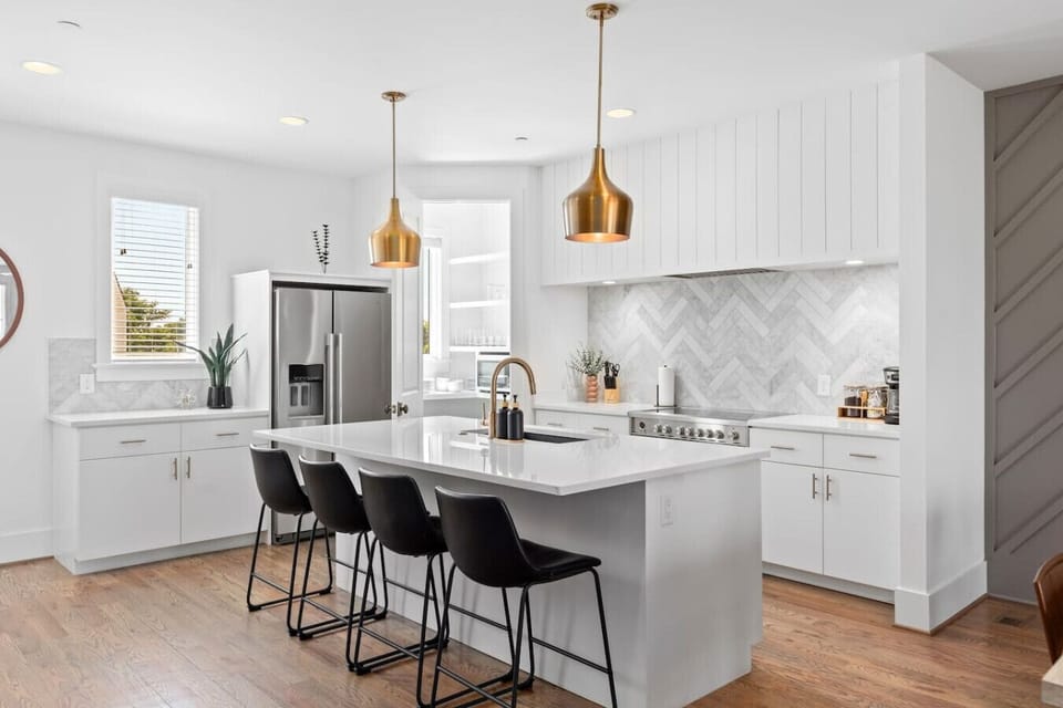 High-end appliances, large pantry, and all the cooking supplies you might need in this bright & refreshing kitchen with seating for four at the island.