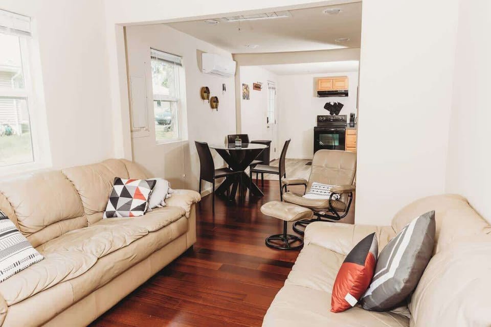 Cozy living space with stylish decor, comfy seating, and an open kitchen.