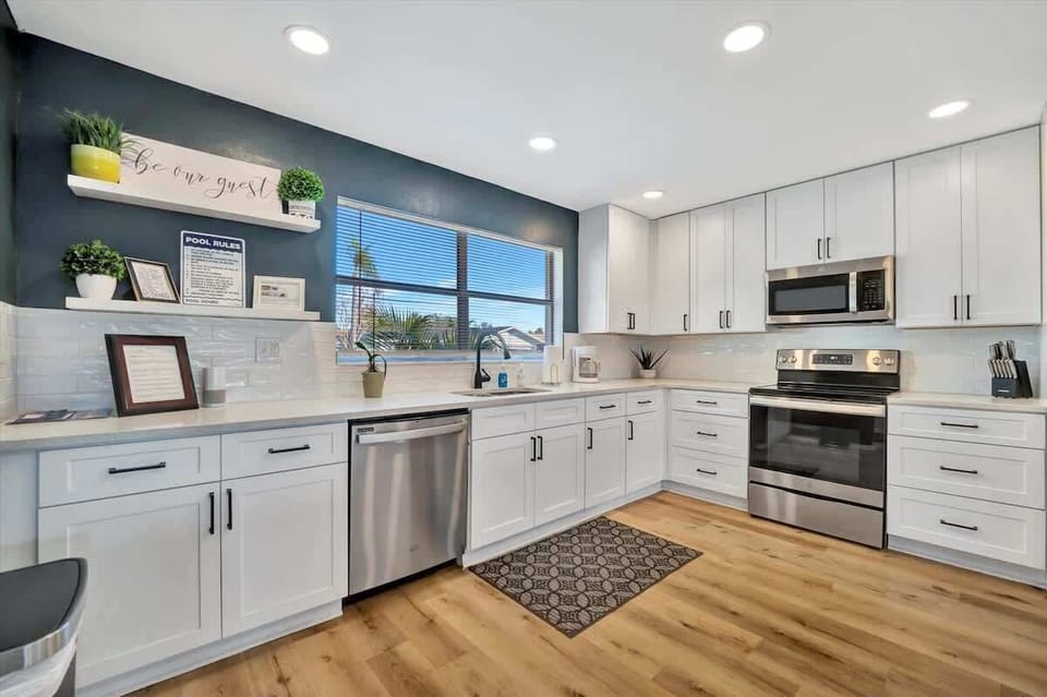 
Here's another fun and marketable Airbnb caption for your kitchen photo:

Whip up some vacation magic in this sparkling kitchen – perfect for a quick snack or a gourmet feast!