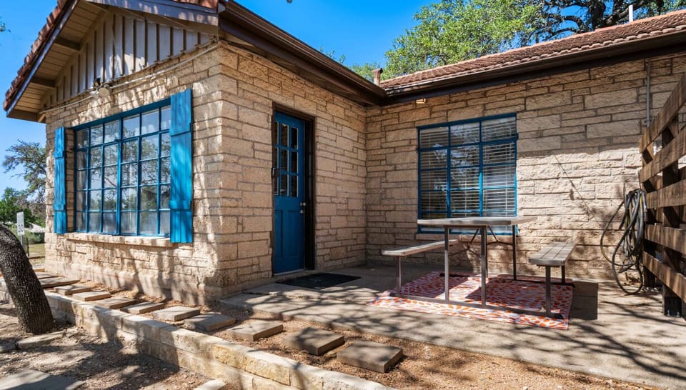 Picnic-ready patio, blue accents, and nature at your doorstep.