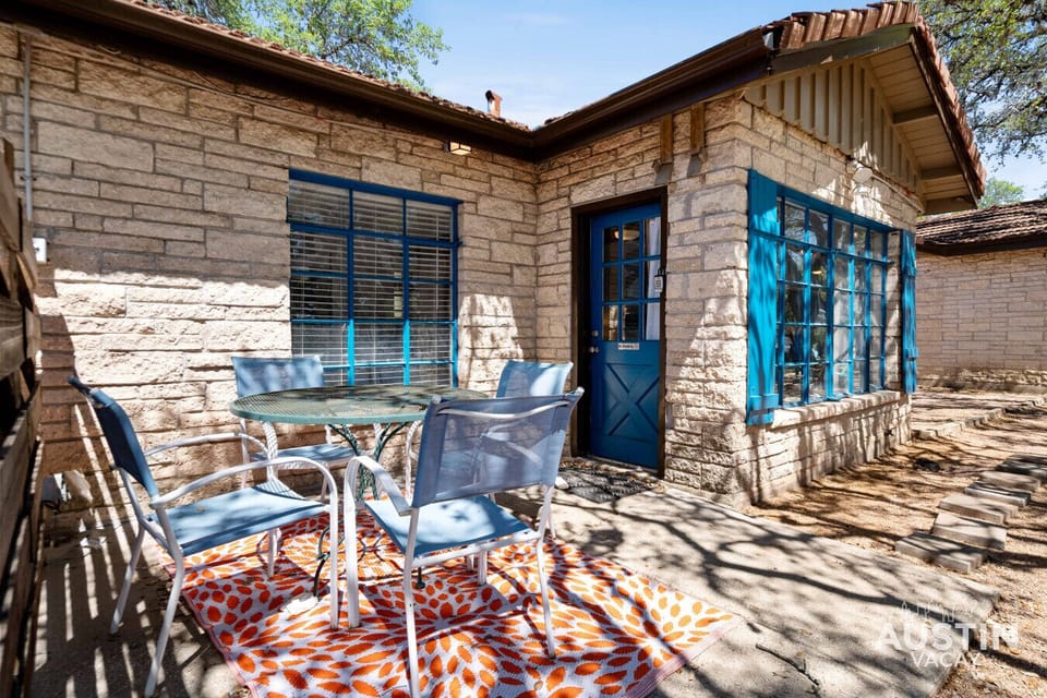 A picture-perfect escape: stone walls, blue windows, and a patio that practically begs for morning coffee rituals.