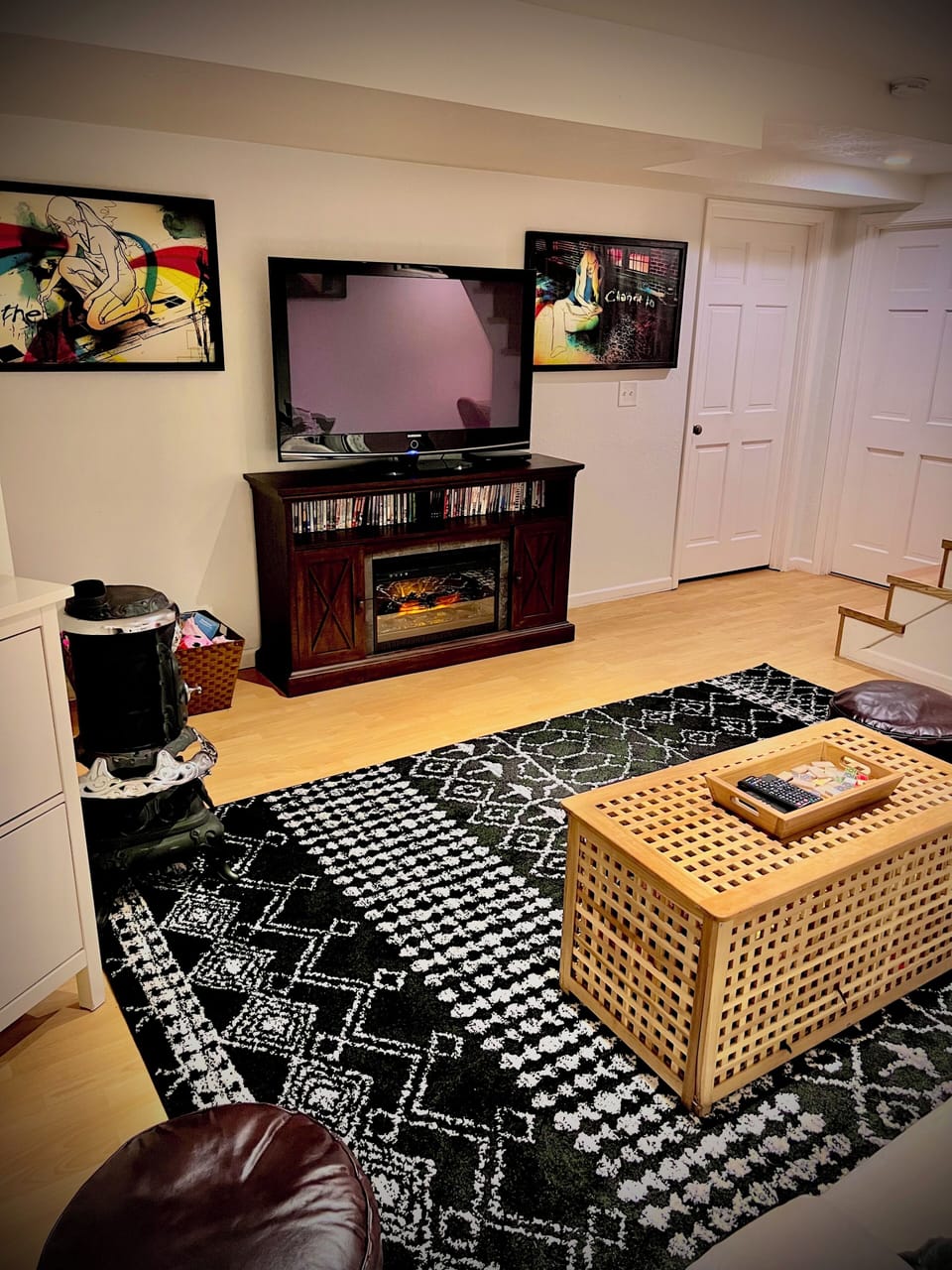 Basement living room provides extra sleeping with couch and queen mattress 