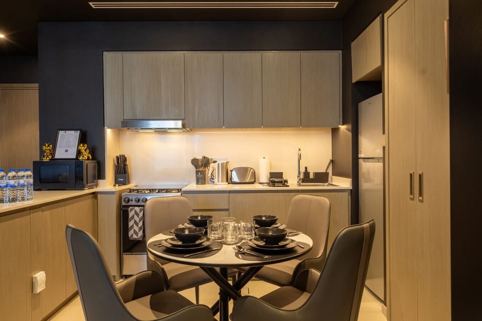 A sleek dining table in the modern kitchen area, perfect for enjoying meals in style within this luxury Downtown Dubai vacation home.