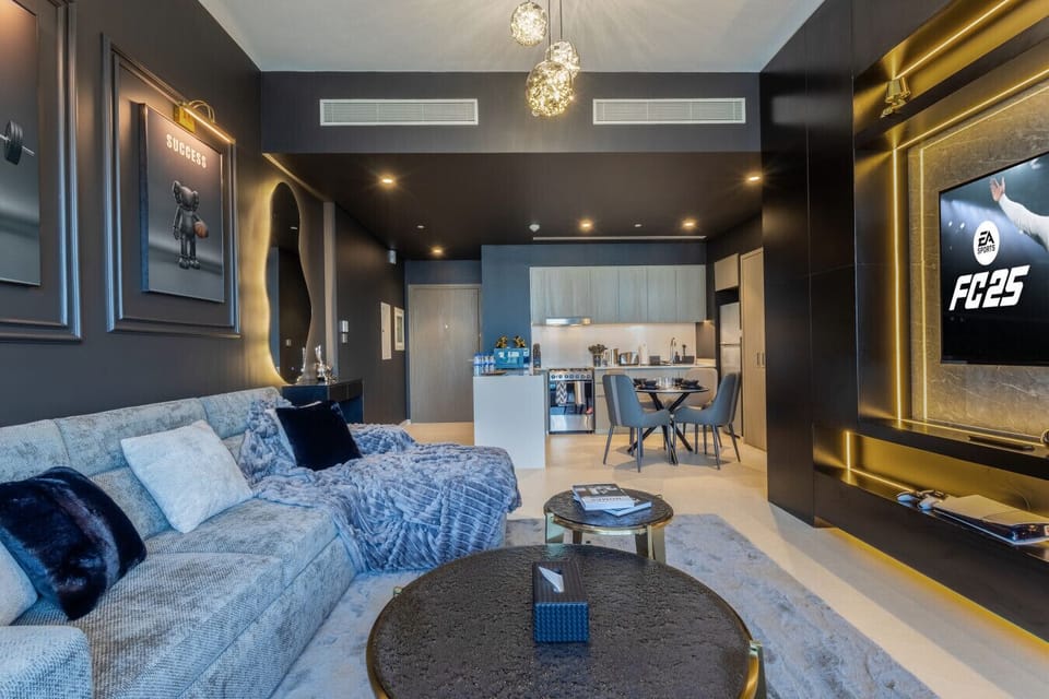 A modern living room with a smart TV, plush sofa beds, and stylish decor, creating the perfect space for relaxation and entertainment in a luxury Downtown Dubai apartment.