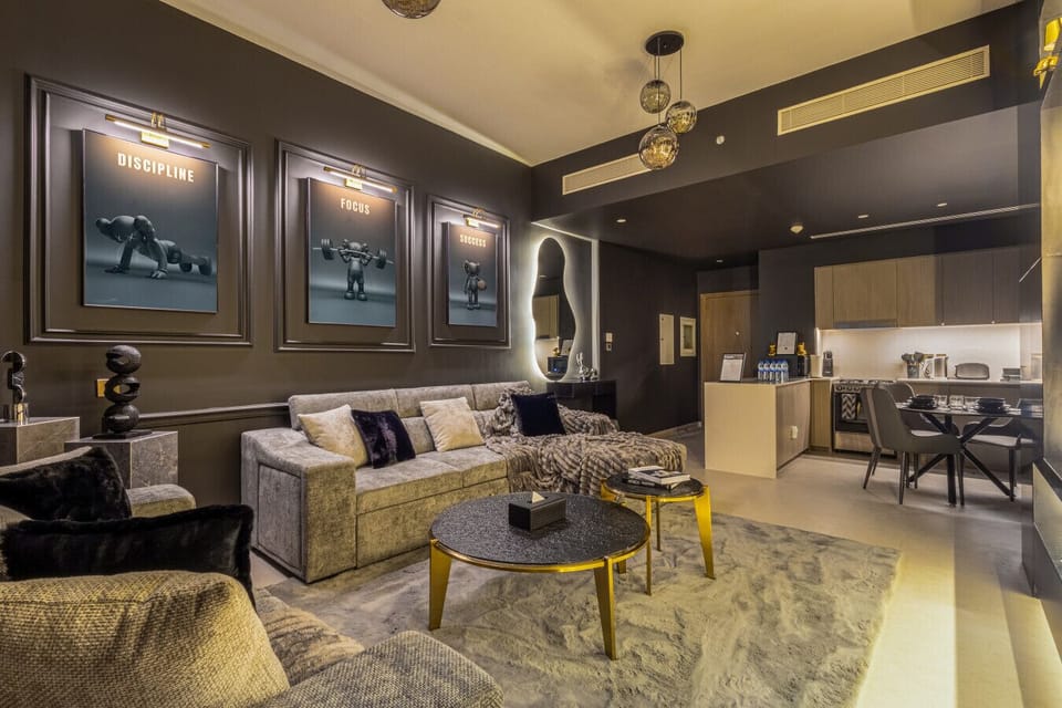 A spacious living room featuring a comfortable sofa bed and elegant dining table, designed for relaxation and dining in style within this luxury Downtown Dubai vacation home.