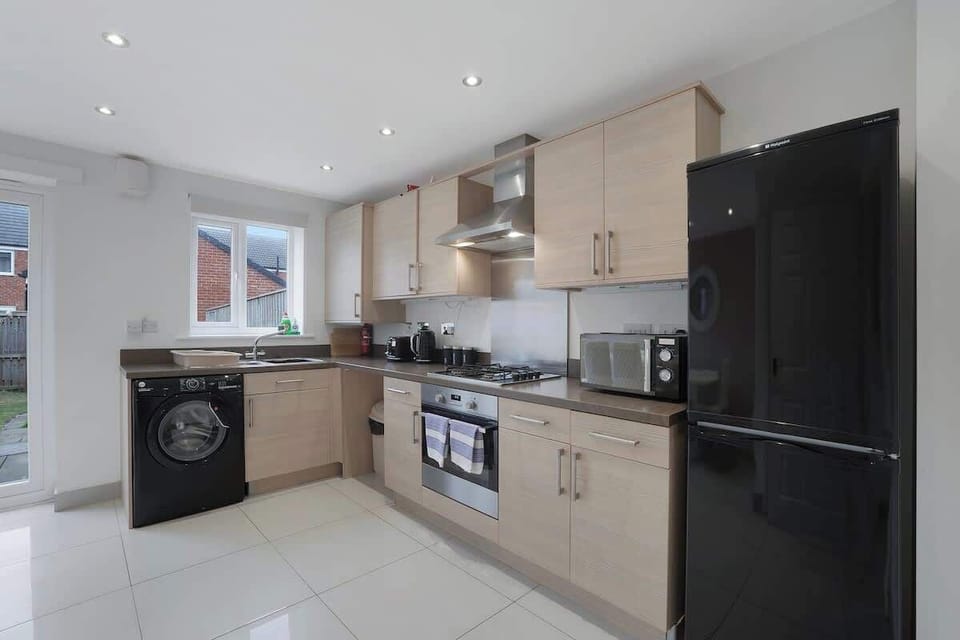 Kitchen equipped with all essentials, including a washer & dryer, oven, fridge and full cookware set.