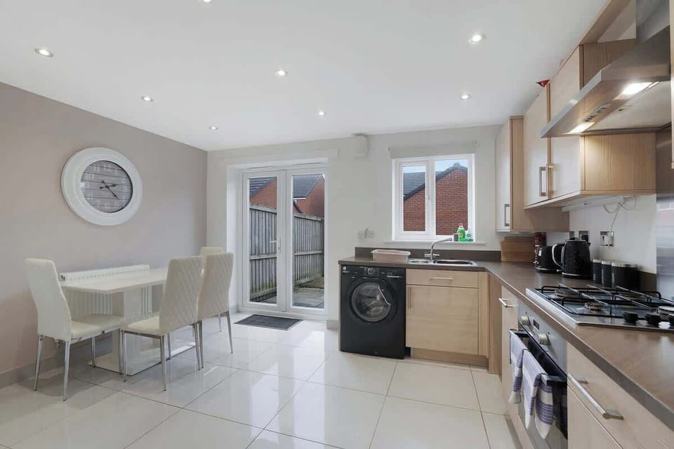 Kitchen equipped with all essentials, including a washer & dryer, oven, fridge and full cookware set.