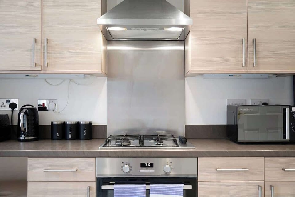 Kitchen equipped with all essentials, including a washer & dryer, oven, fridge and full cookware set.