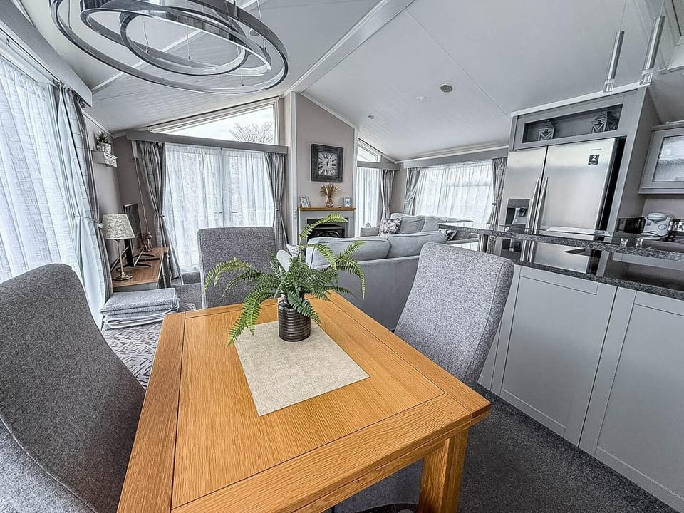 Situated conveniently opposite the kitchen, this dining table is the ideal spot for sharing meals, playing board games, or simply planning your next day's adventure on the Norfolk coast.