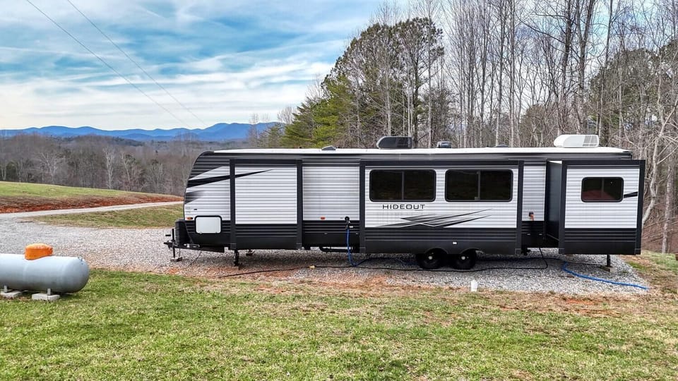 Mountain views stretch beyond the trees—your private retreat on wheels awaits.