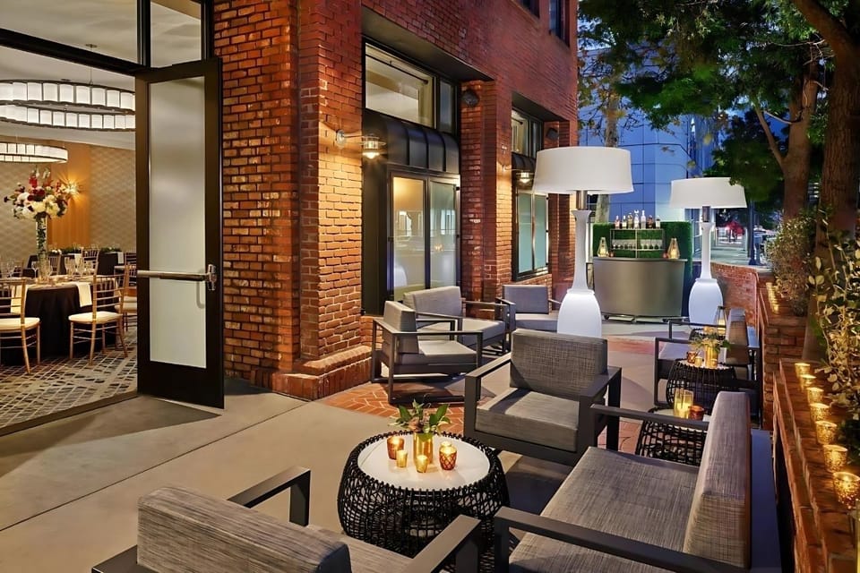 Sip evening drinks on a cozy patio with warm lighting.
