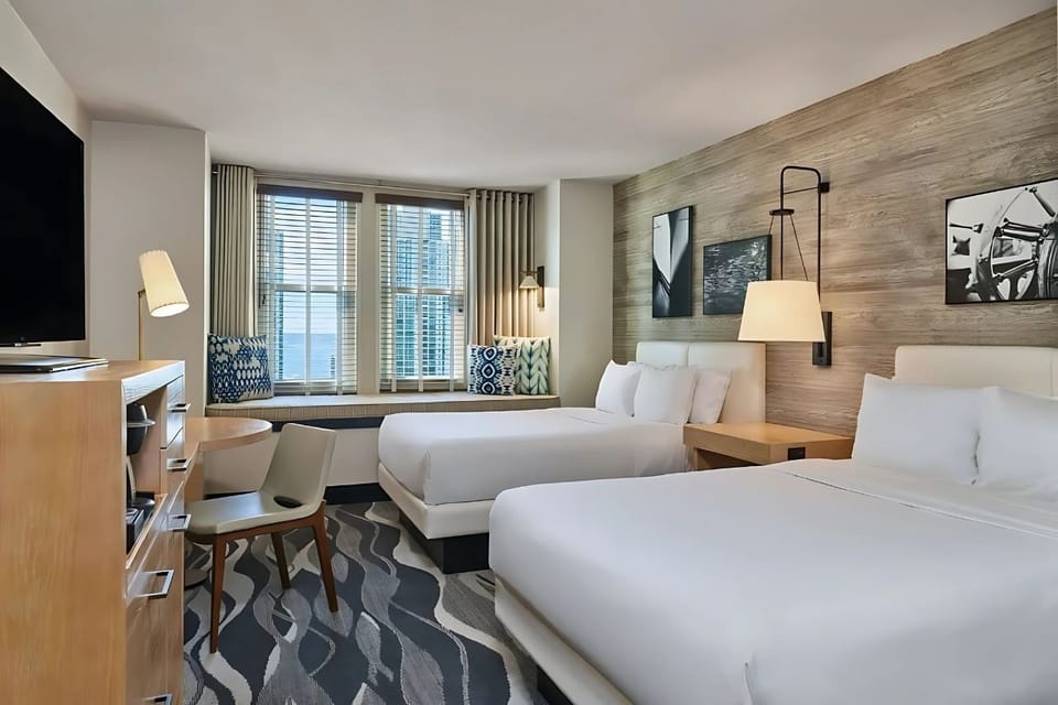 Unwind in a bright double-queen room with cozy window nook.