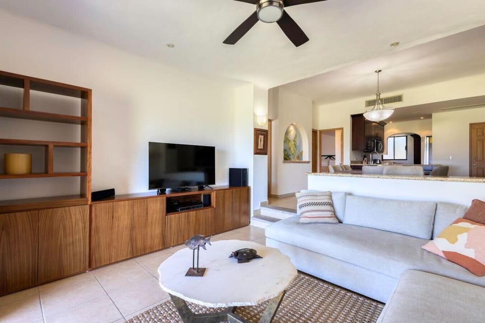 Relaxing lounge with flat-screen TV and built-in shelving.