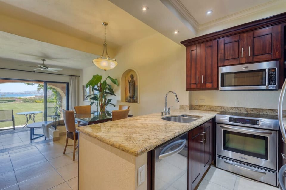 Open kitchen connected to dining area with views.
