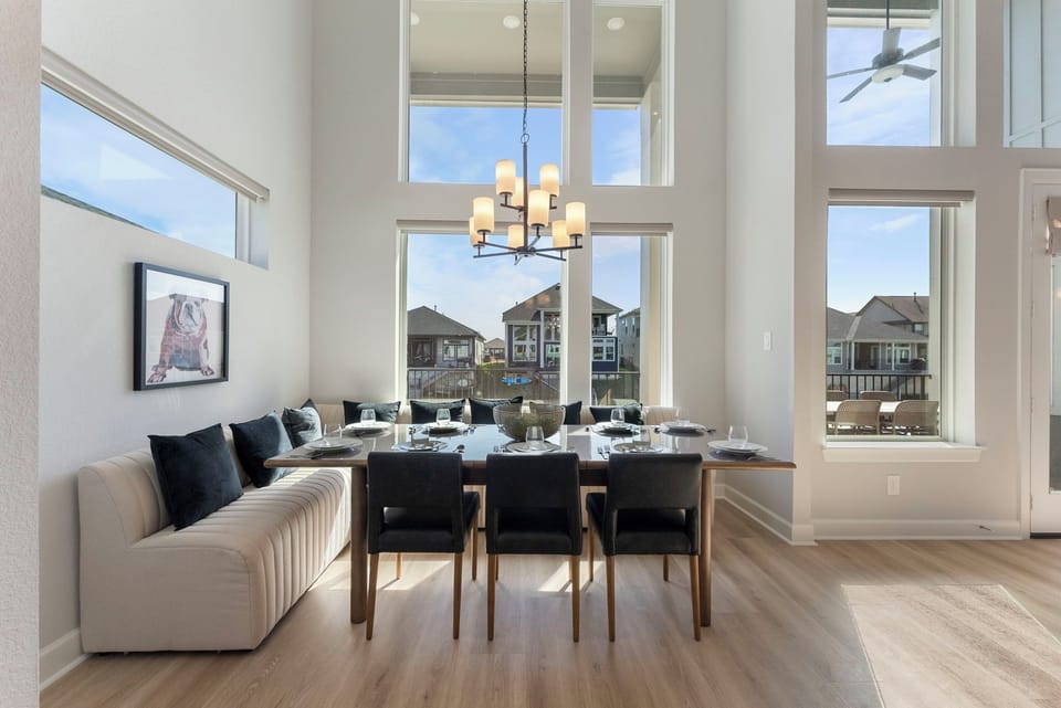 Dining table seats 8-10 comfortably and there are 6 more barstools at the island