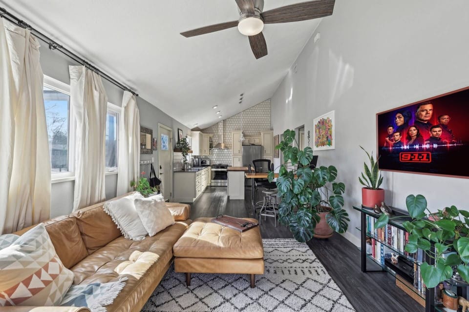 Lots of seating in the living room with TV and live plants