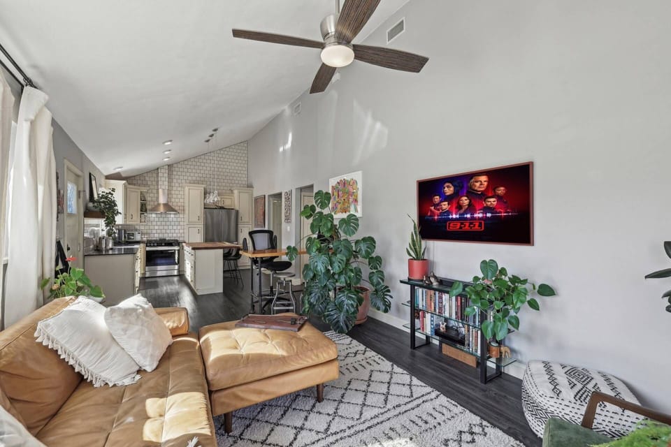 Open concept living room with TV and huge sofa.
