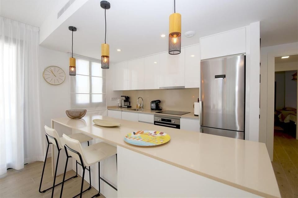 Another view of the kitchen with breakfast bar for two guests