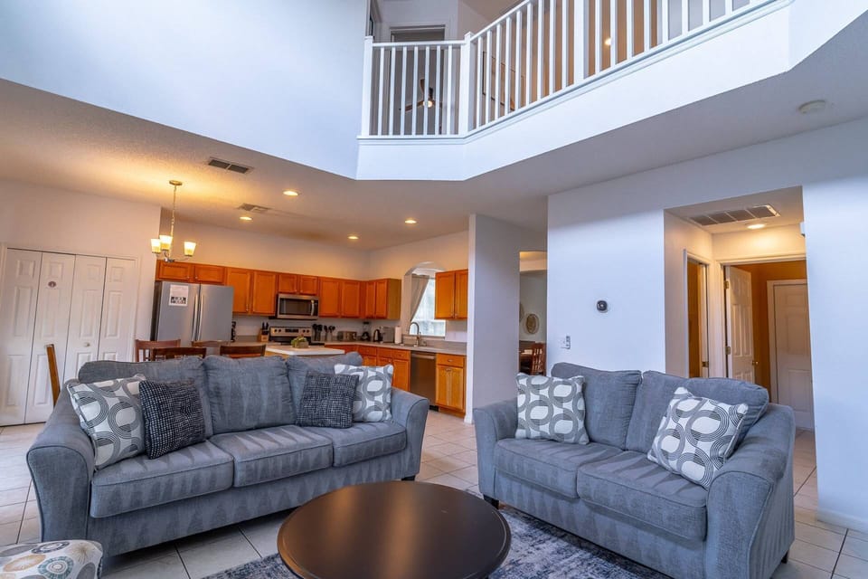 Bright and open living area with access to the kitchen and the second floor loft