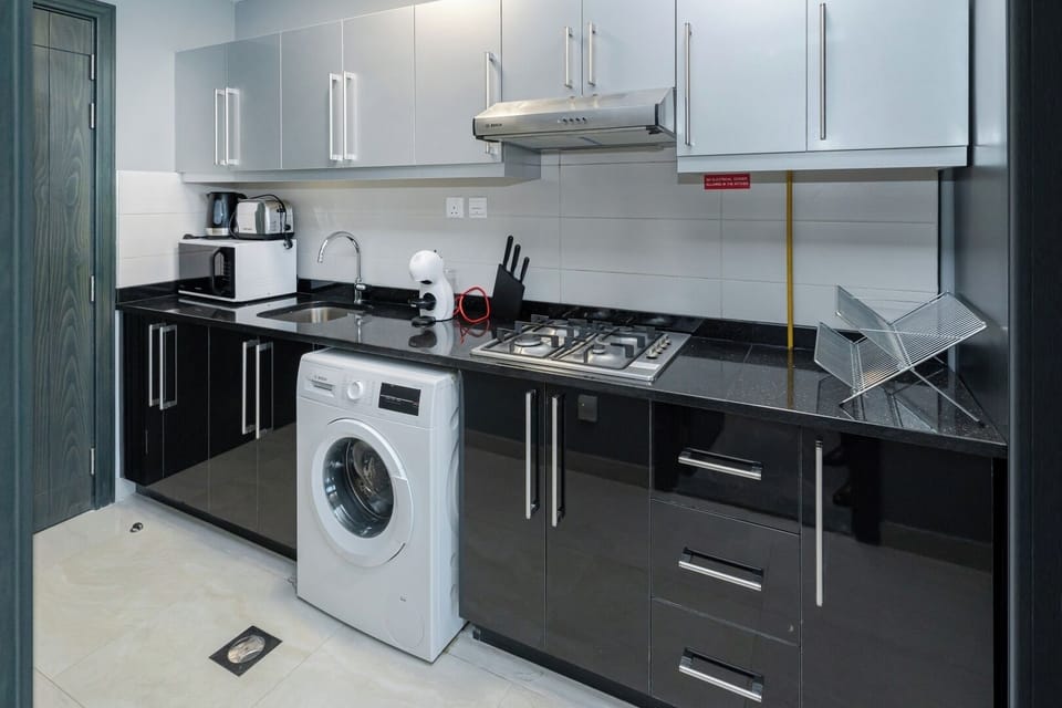 Fully equipped kitchen with private laundry