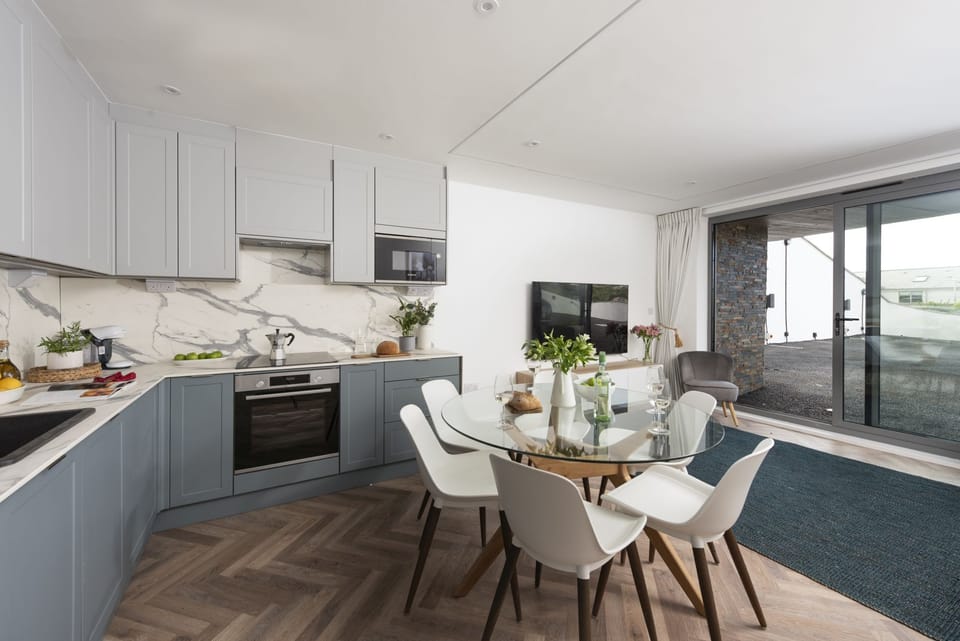 Kitchen and dining area with the sofa and TV with seating for 6 - 2 Oasis Sands