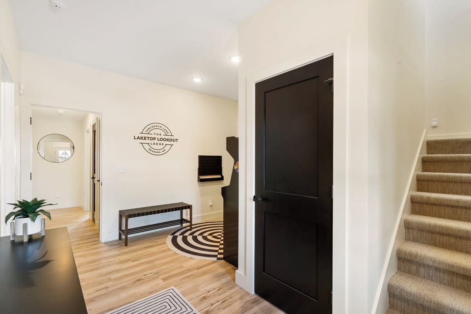 Entry level entertainment and bedrooms. Stairs lead up to the living room, kitchen, and dining plus one more bedroom.