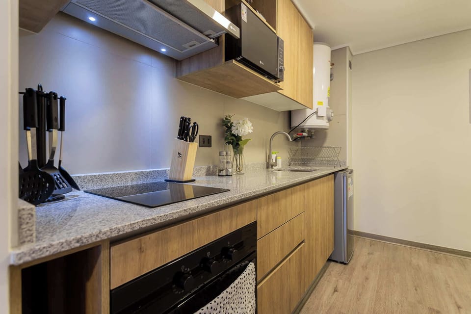 Sleek and modern kitchen with all essentials, perfect for cooking up a delicious meal during your stay.