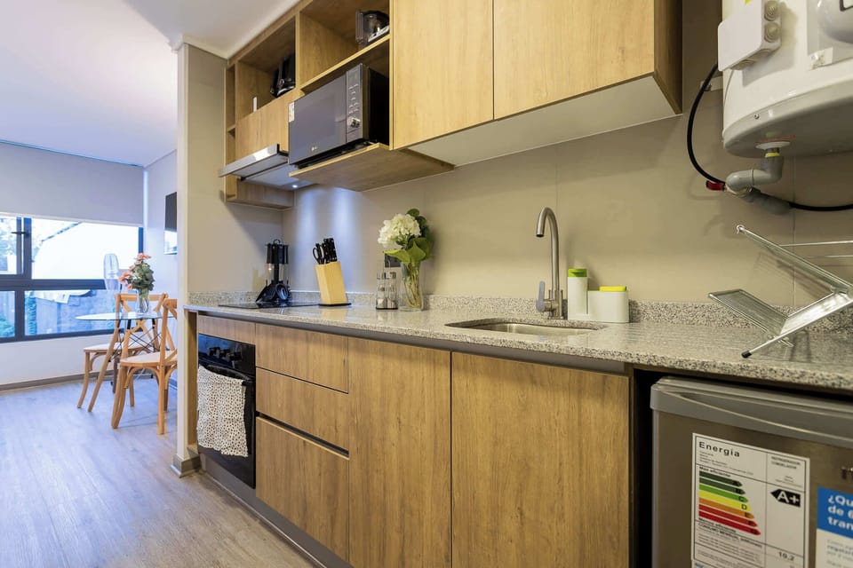 Sleek and modern kitchen with dining area, perfect for enjoying meals with natural light.