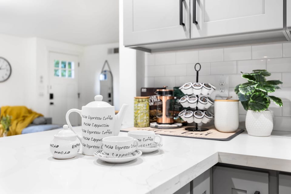 Start your mornings with the perfect cup of coffee or tea in this thoughtfully designed corner. Featuring a coffee pod rack, French press, and charming ceramic mugs, this setup offers everything needed to kickstart your day. 