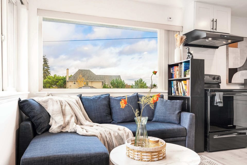 A comfortable and stylish sofa serves as the centerpiece of the living room, offering plush seating and a modern design. Perfect for relaxing, entertaining, or enjoying your favorite shows.
