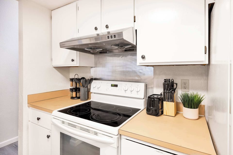 This well-equipped kitchen features a sleek stovetop and essential cooking tools, making it easy to whip up meals during your stay. The countertop is spacious and thoughtfully organized for convenience.