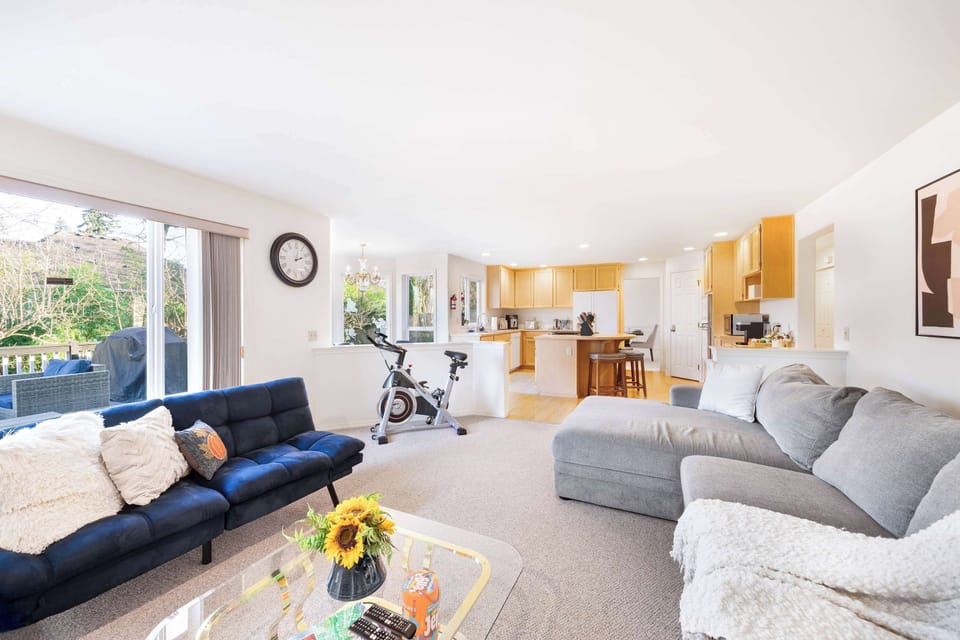 Large sliding doors lead to a spacious deck with outdoor seating and a BBQ grill for relaxing in the fresh air.