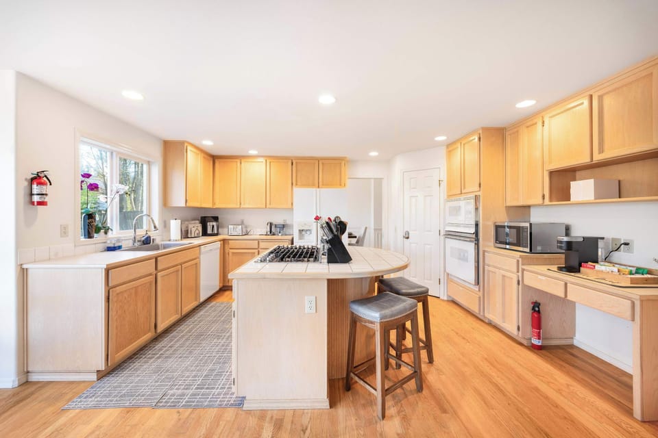 A warm and inviting kitchen with generous counter space, a center island, and high-quality appliances, perfect for preparing delicious meals.